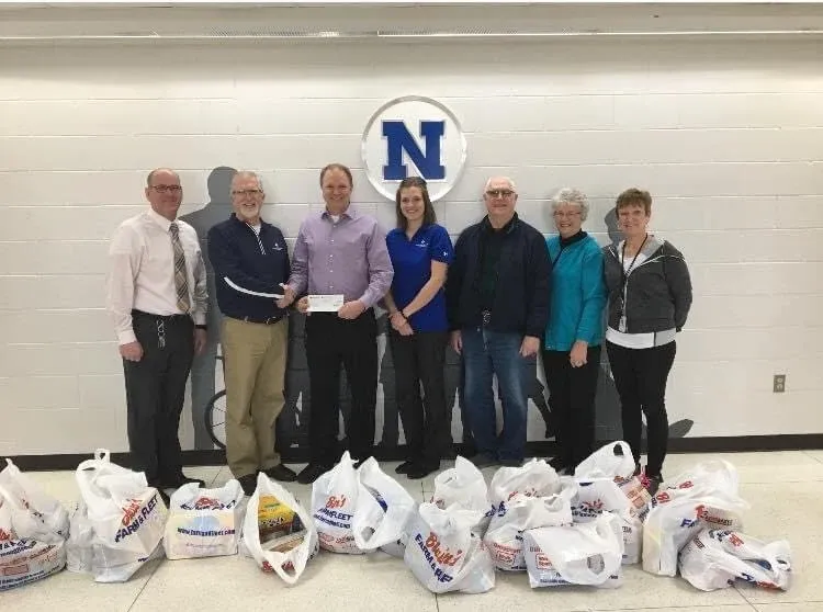 Church volunteers gathered with donated food and supplies